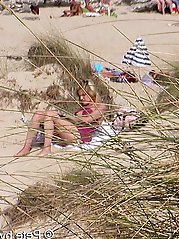 A mature woman feels that she is not being watched on a beach for nudists.