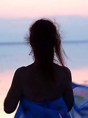 On sand seminude with light-color vase